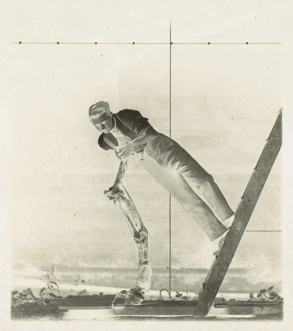 Man on ladder spraying garden hose at an angle toward shed roof edge